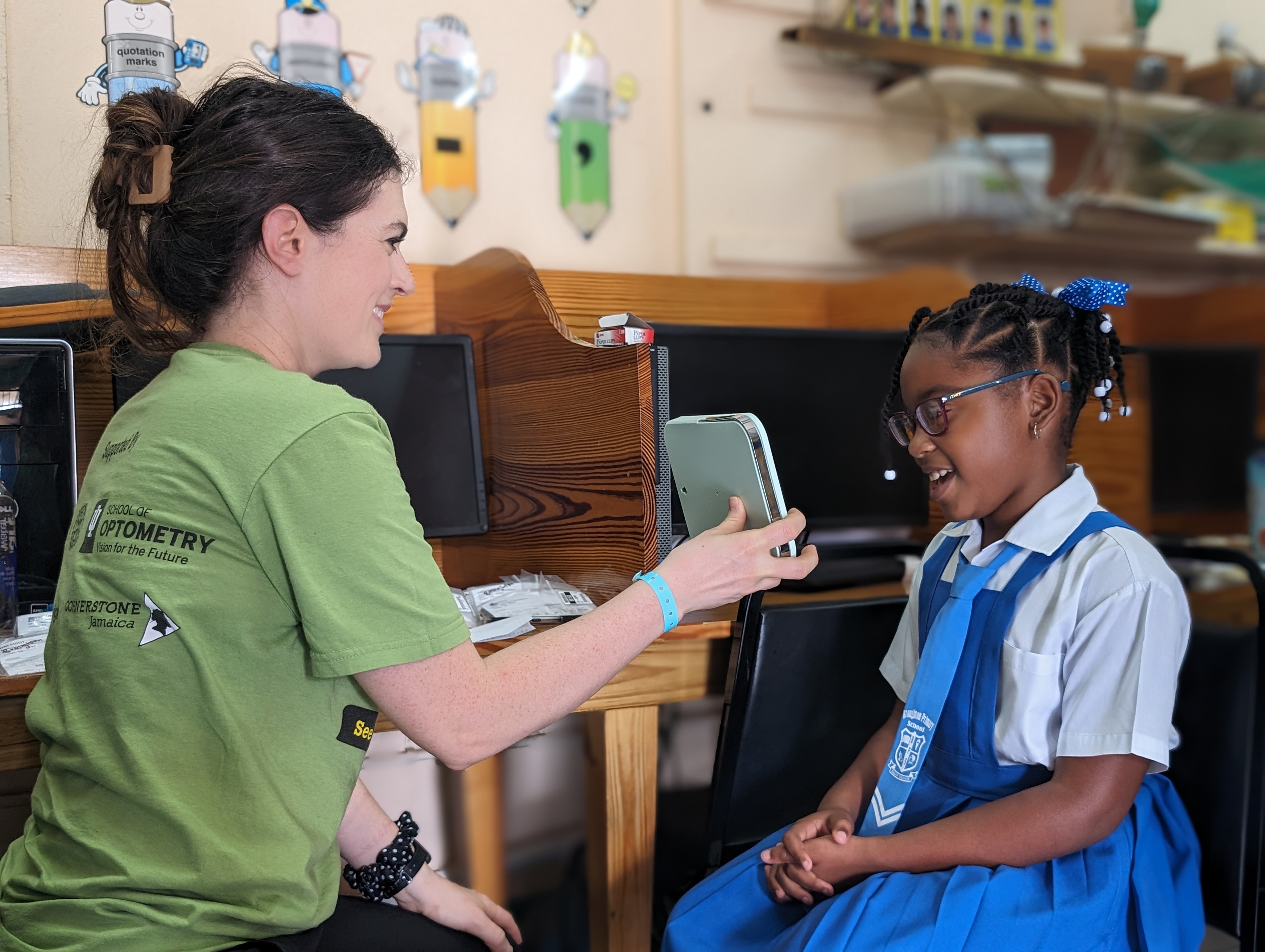 A child views themselves in a mirror wearing new glasses